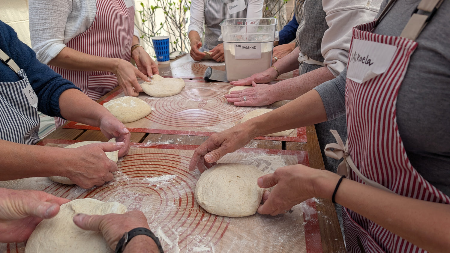 Group of people shaping dough together during a private cooking class in Albuquerque