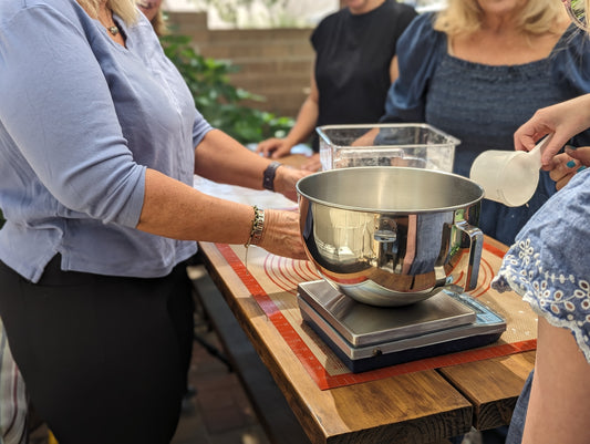 Group of participants working on bread dough during a hands-on group cooking class in Albuquerque