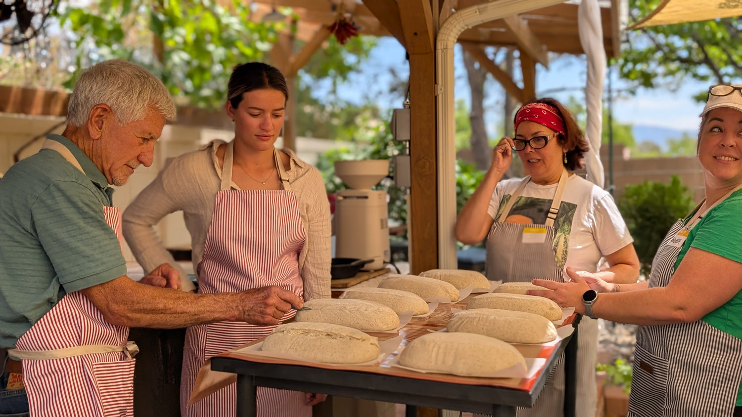 Students scoring artisan bread dough during a private baking class in Albuquerque