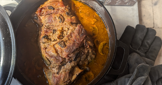 Authentic barbacoa slow-cooking in a traditional wood-fired brick oven at Sherwood Coffee 'n' Bread in Albuquerque.