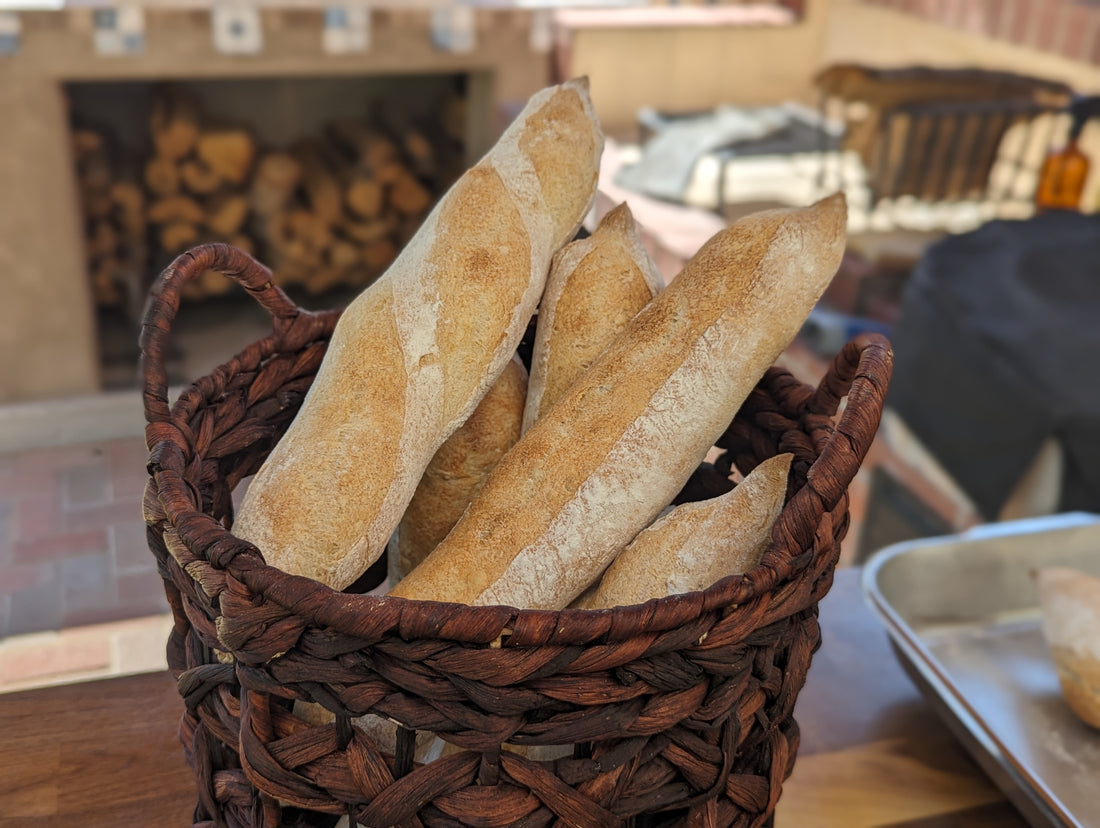 Hands-on baguette baking class in Albuquerque with students learning to bake baguettes in a traditional brick oven