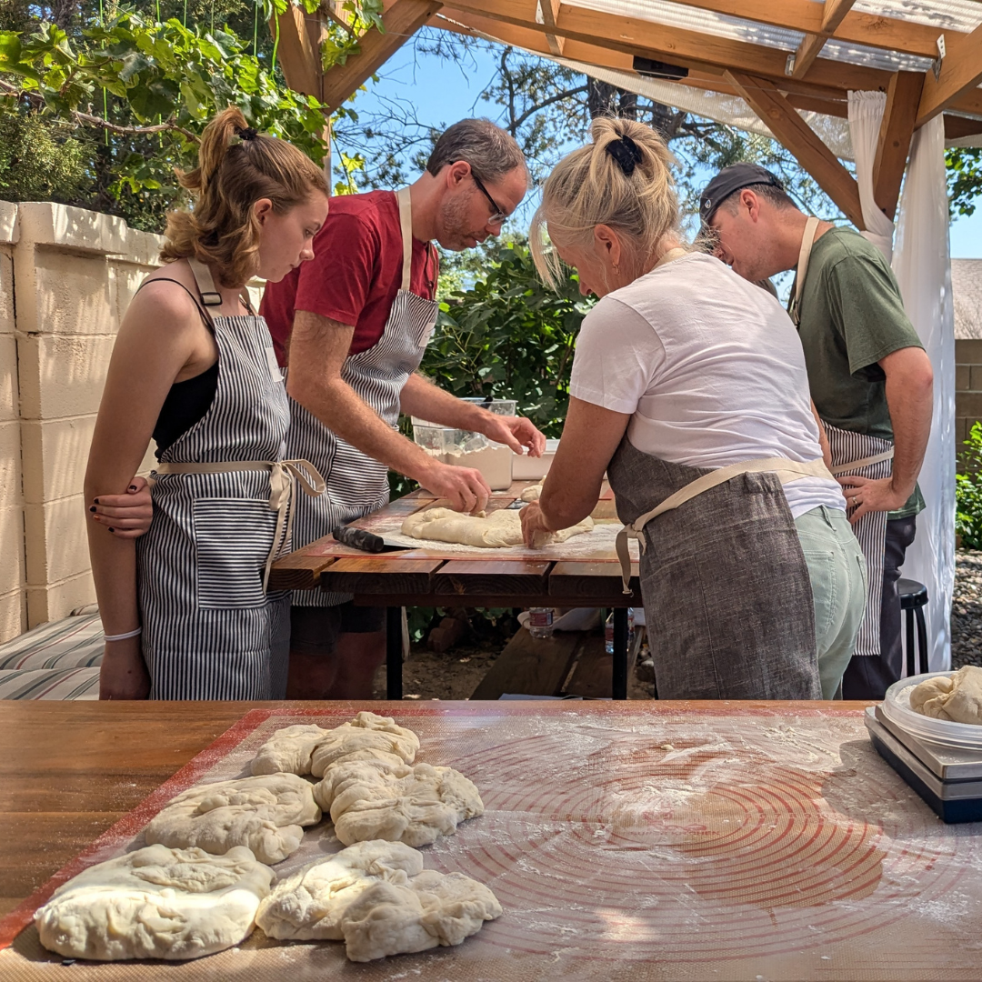 Chef guiding a small group during a private cooking class, teaching personalized techniques in Albuquerque.