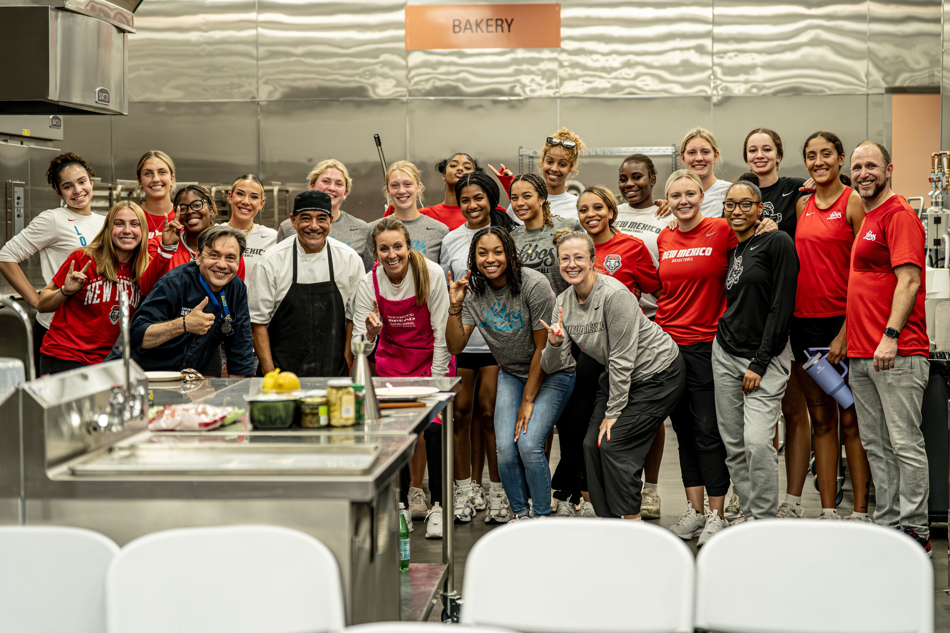 Amy Eagan with the UNM women’s basketball team at a Sherwood cooking event