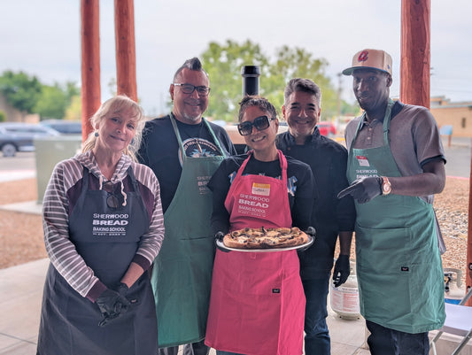 Group enjoying Team Building Activities in Albuquerque with hands-on bread and pizza experiences.