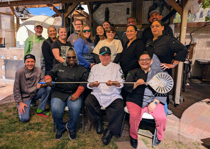 Team taking group photo after pizza cooking class in Albuquerque